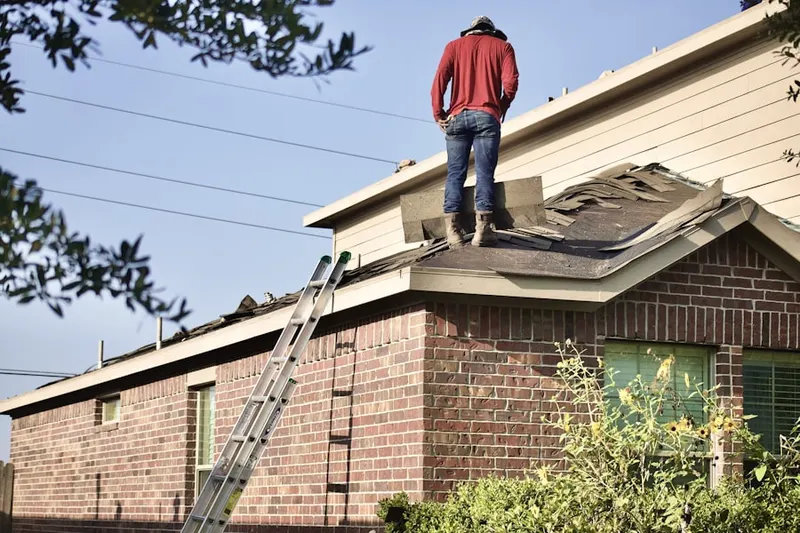 Professional roofer working on a residential roof in Richland Farms